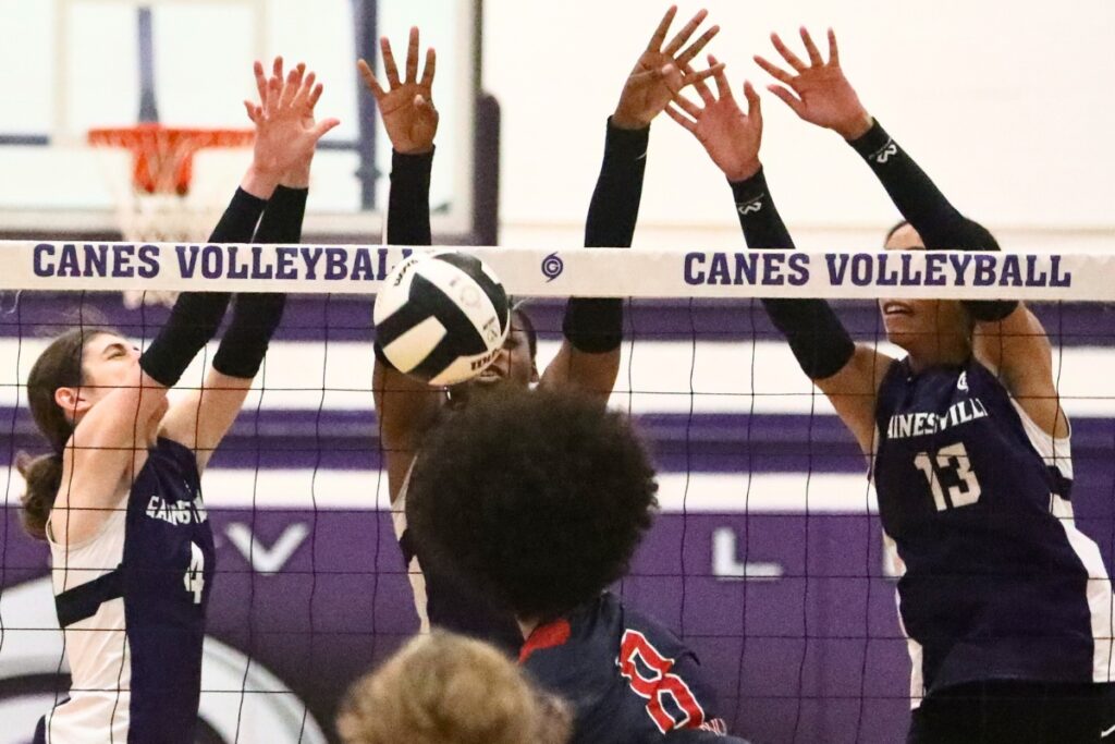 Gainesville's Chloe Petrik (4), Nicole Ellis and Brooklyn Tealer (13) block against Vanguard on Tuesday.