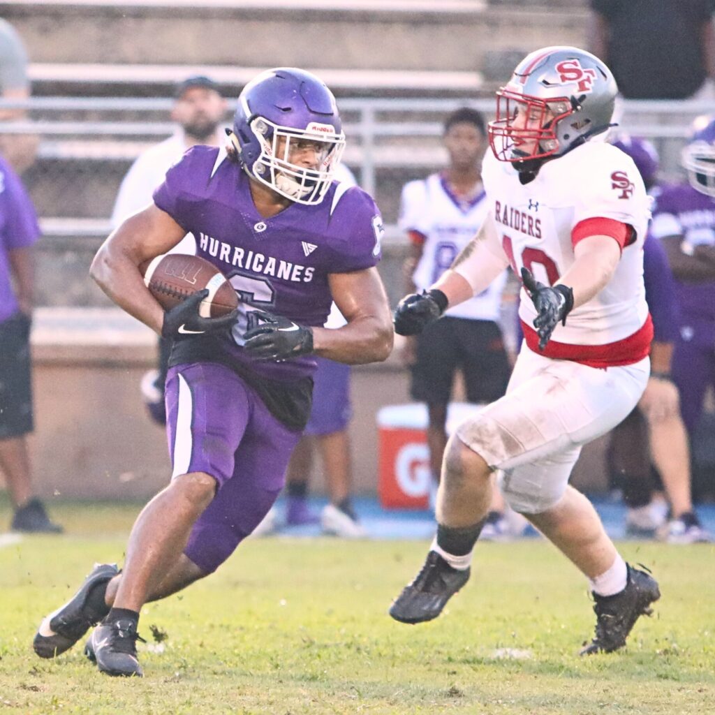 Gainesville's David Wilbon runs past Santa Fe's Jack Wheeler in the second quarter on Thursday.