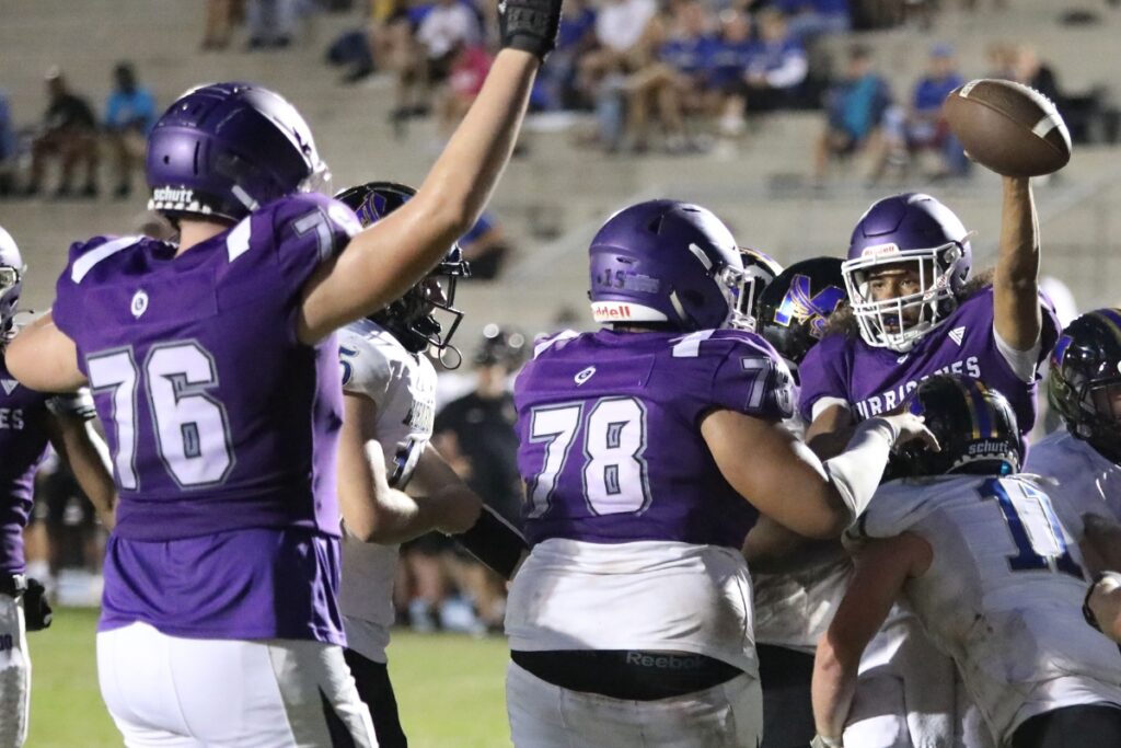 Gainesville's Kane Smith scores a second quarter touchdown to tie the game 7-7 against Menendez on Friday.