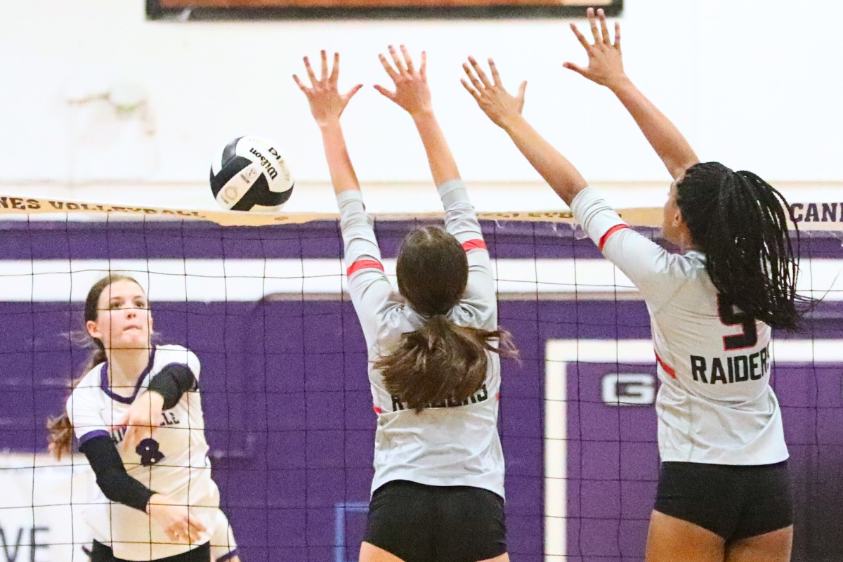 Gainesville's Rowan Kage (left) with a hit against Santa Fe's Lillian Logan and Joslynn Sanjurjo on Wednesday.
