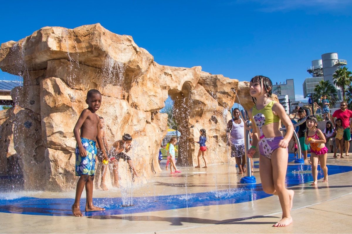 Kids playing in the water feature at Depot Park. Kids playing in the water feature at Depot Park.