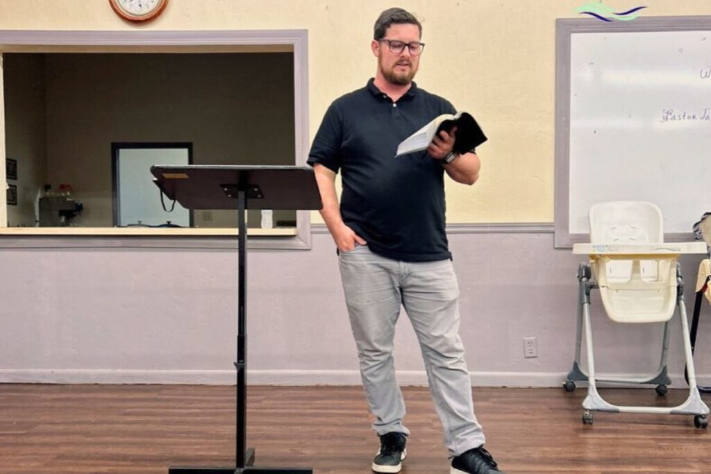 Pastor Jacob Newton reads the Bible to his congregation at High Springs Church of God.
