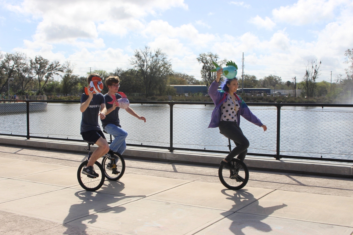 People riding unicycles at Depot Park. People riding unicycles at Depot Park.