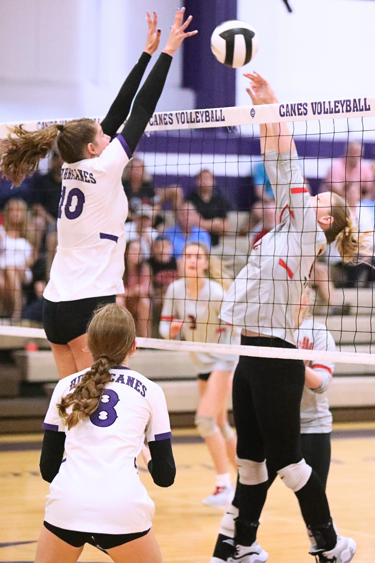 Santa Fe's Alexis Rhoden (right) with a hit against Gainesville's Charlotte Gravlee on Wednesday.