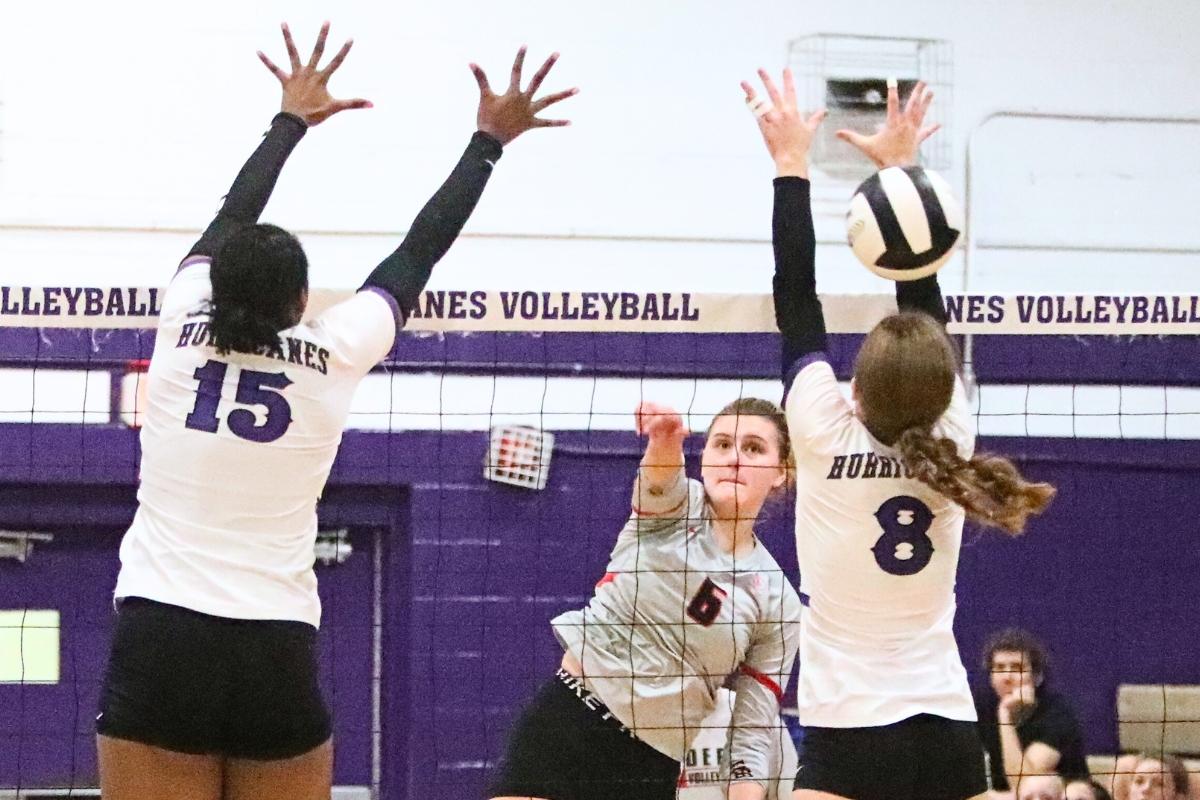 Santa Fe's Anna Carlisle with a hit over Gainesville's Rowan Kage on Wednesday.