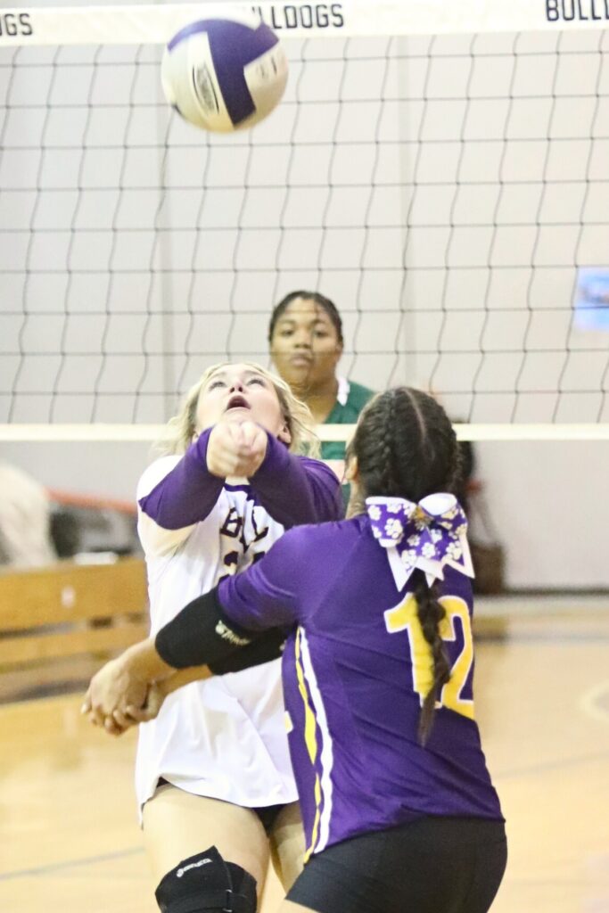 Bell's Anna Hutto (24) and Alaina Thomas (12) go after a dig against Eastside on Tuesday.