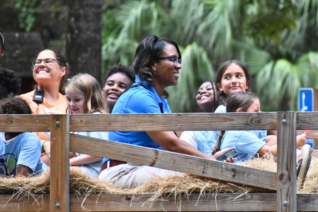CTAC Board Chair Tina Certain rides the hayride with Girls Place students.