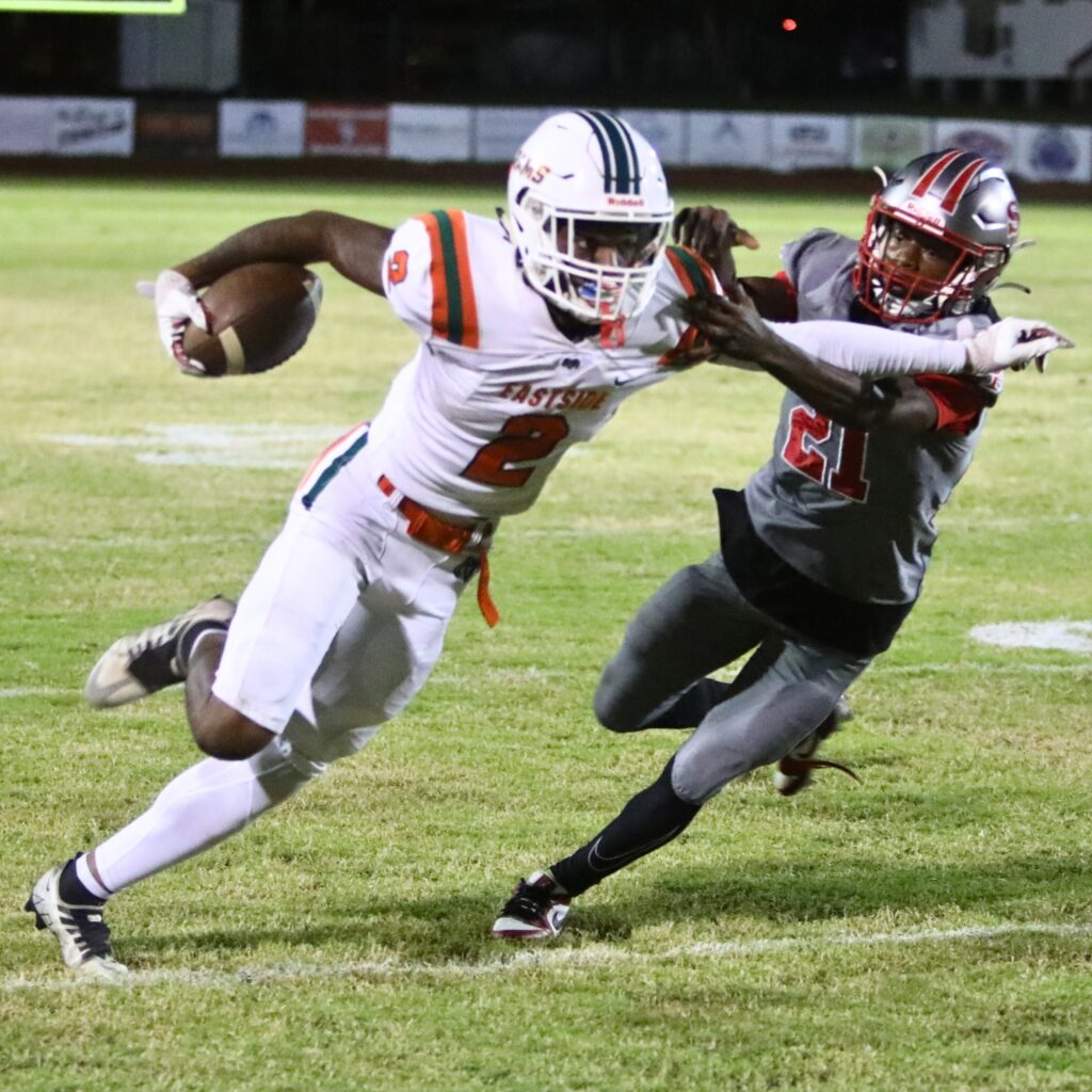 Eastside's Antoneo Wilson with a stiff arm on Santa Fe's Jalen Ford on Friday.