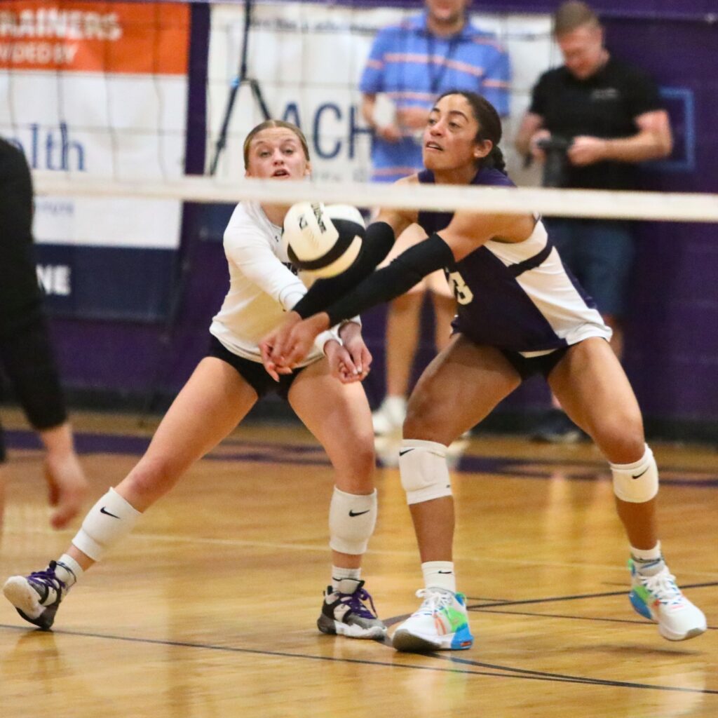 Gainesville's Madison Howard (left) and Brooklyn Tealer go for a dig against Navarre on Wednesday.