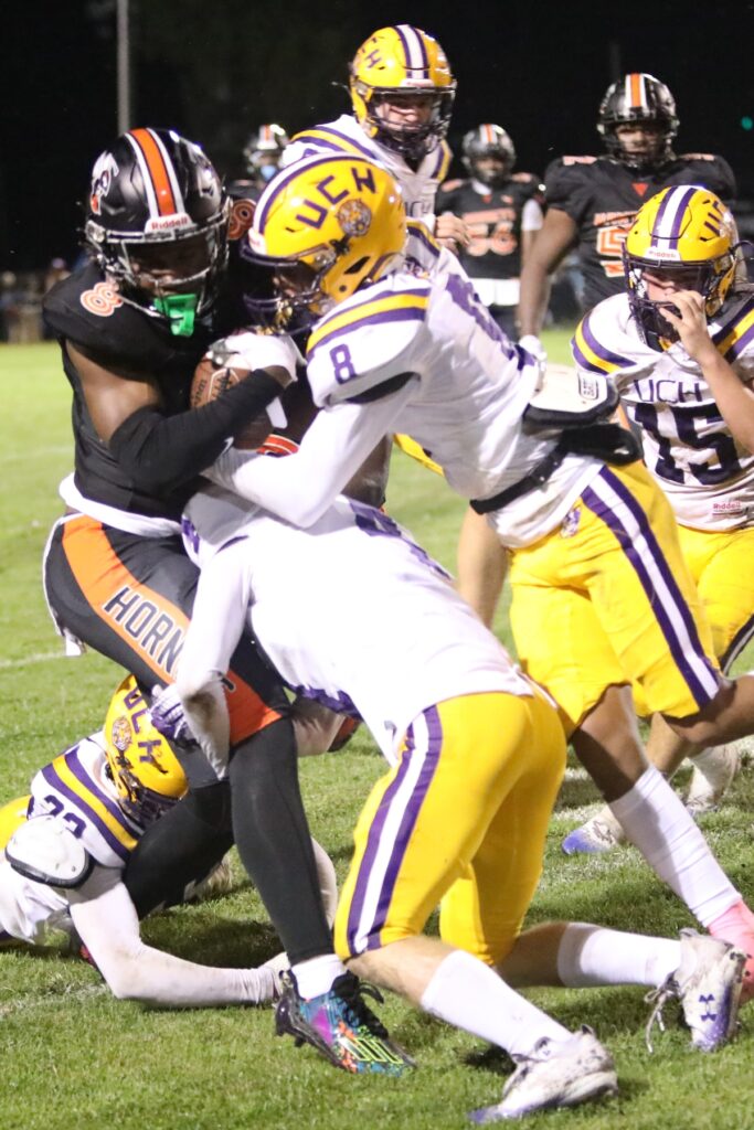 Hawthorne's Caleb Rollerson gets tackled by Union County defenders after a reception on Friday.