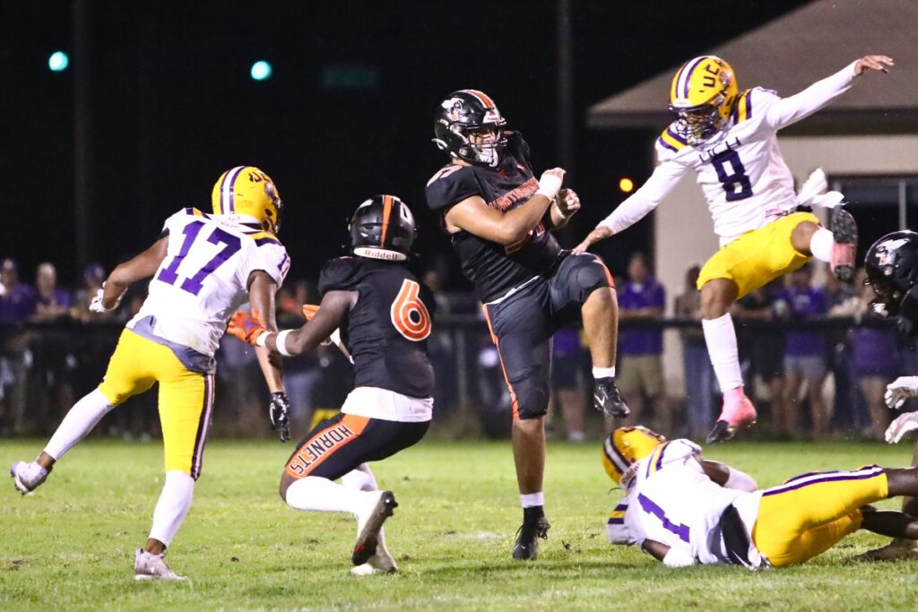 Hawthorne's Josues Knapp gets a second quarter punt off under heavy pressure by Union County on Friday.