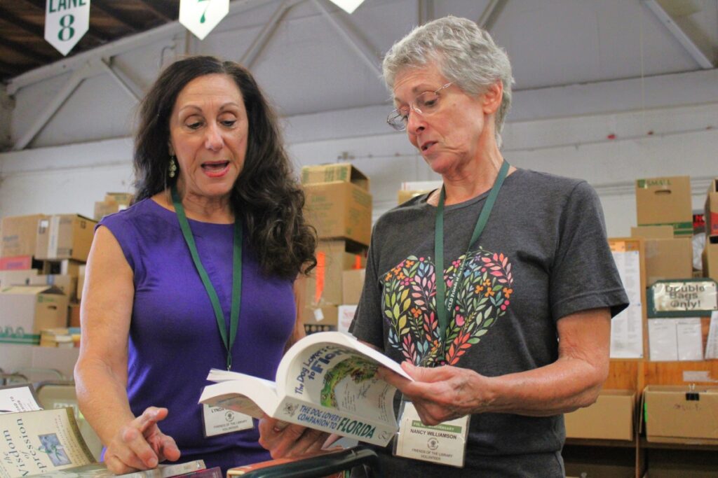 Lynda McKenzie and Nancy Williamson discuss how to categorize a recent donation before the fall 2023 sale.