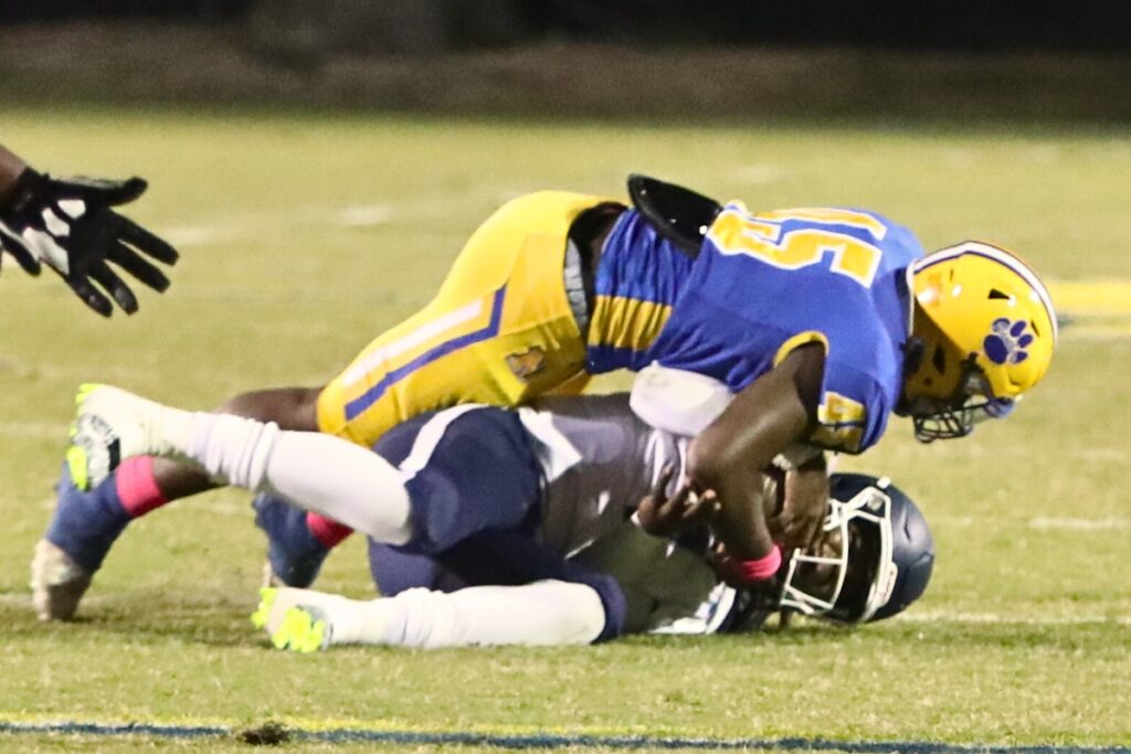 Newberry's Zavian Gillum with a first quarter sack on P.K. Yonge's Lawrence Wright Jr. on Friday.