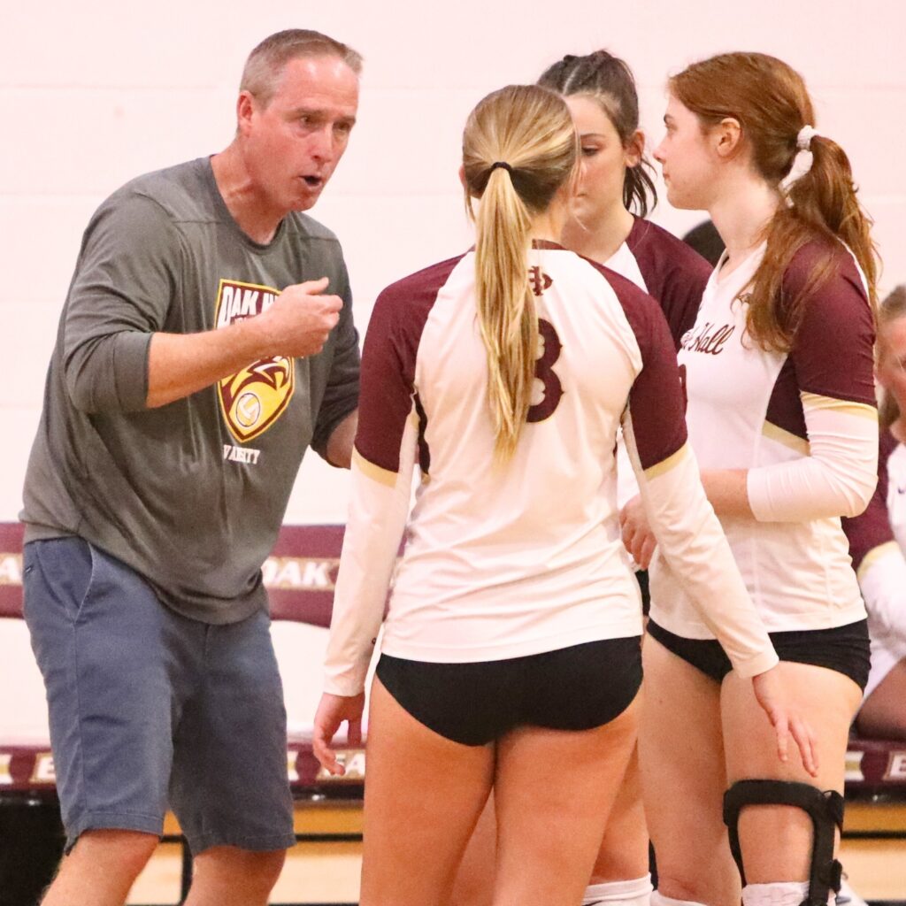 Oak Hall coach Perry McDonald talks to Ave Scorpio, Cassidy McDonald and Pene Moser during a timeout against North Florida Christian on Tuesday.