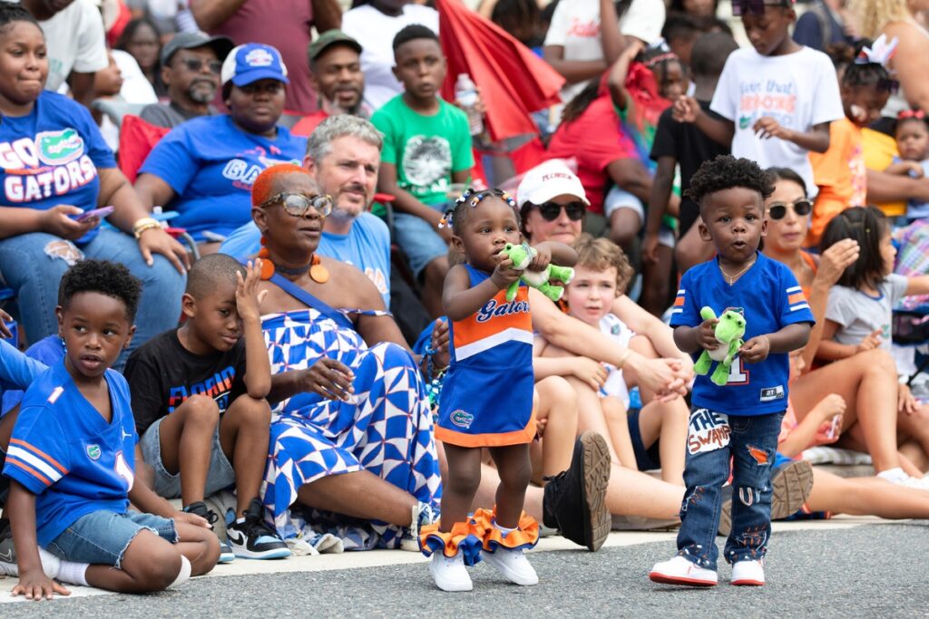 Spectators enjoy the UF Homecoming Parade on Friday.