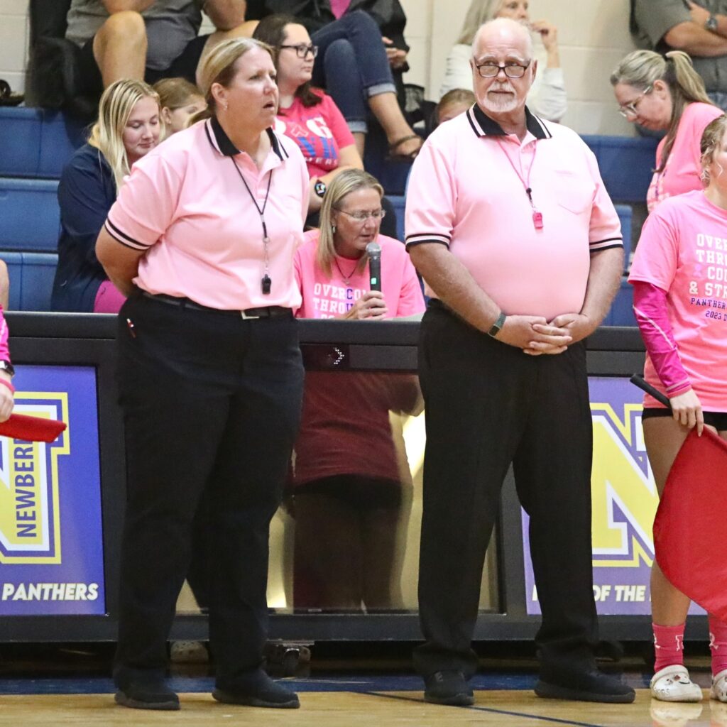 The officials sported pink shirts in Monday's volleyball match against Chiefland and Newberry.
