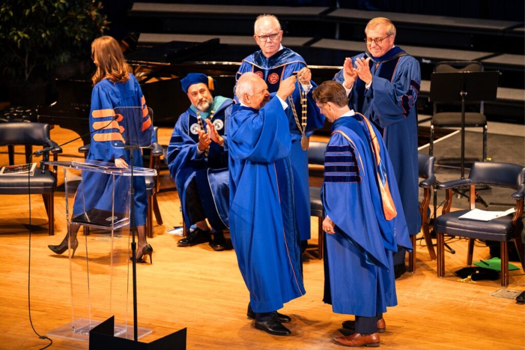 Board of Trustees Chair Mori Hosseini presenting Ben Sasse with the Symbols of Office.