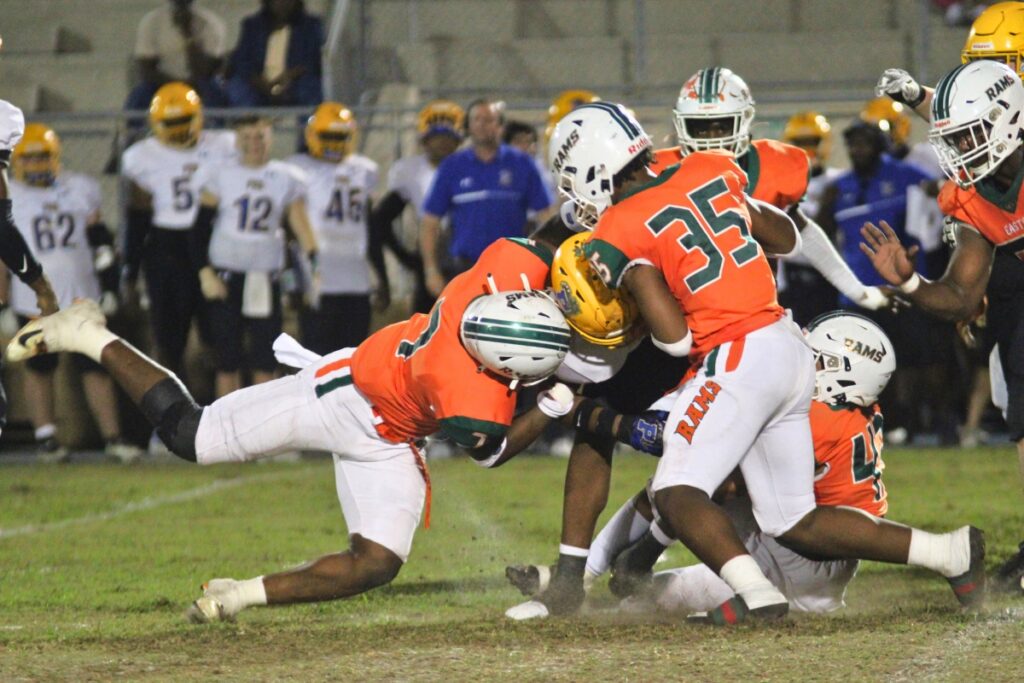 Eastside defenders combine to stop a run behind the line of scrimmage against Palatka on Friday.