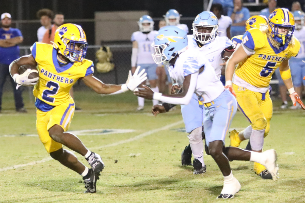 Newberry's Kaleb Woods attempts to stiff arm Chiefland's Jamarion White on Friday. Photo by C.J. Gish