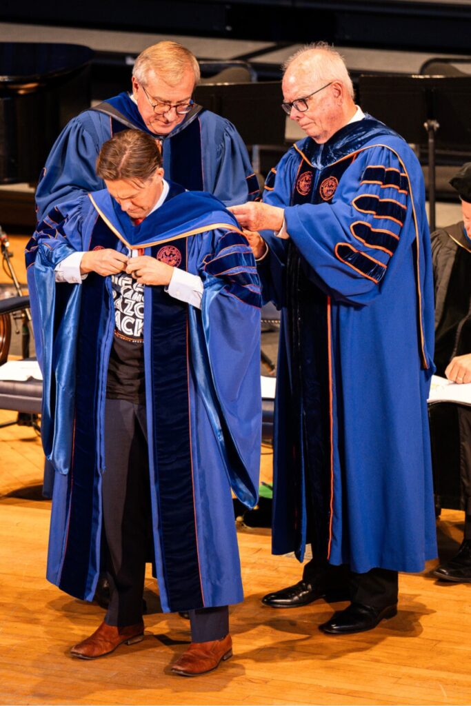 President Emeritus Kent Fuchs (left) and President Emeritus Bernie Machen (right) presenting Ben Sasse with the Symbols of Office.