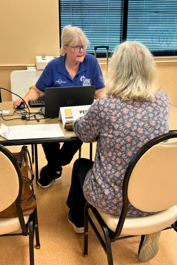 SHINE counselor Peggy Stedman assists a consumer with reviewing her Medicare options.