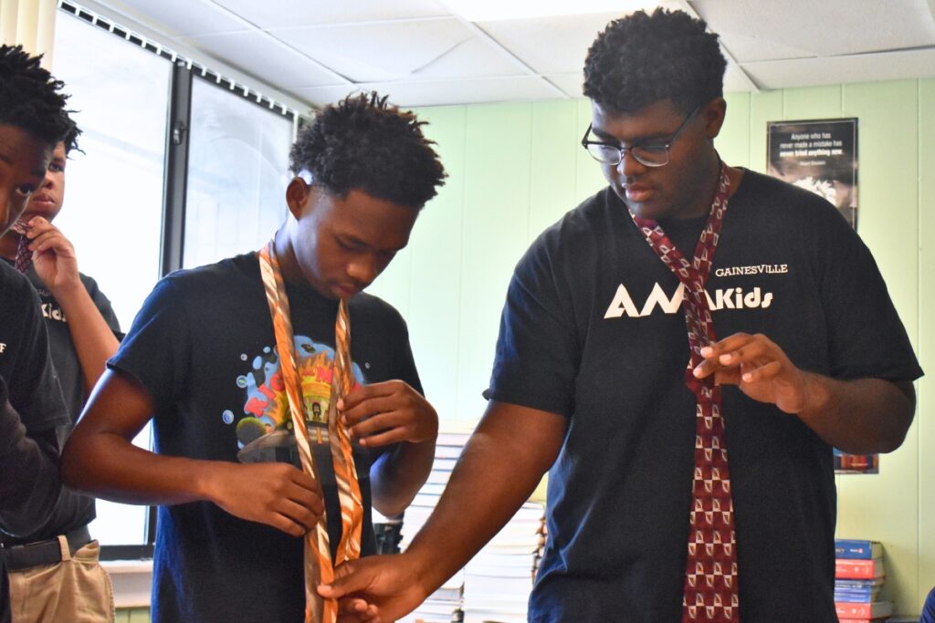 Students learn to tie a necktie in their vocational skills class.