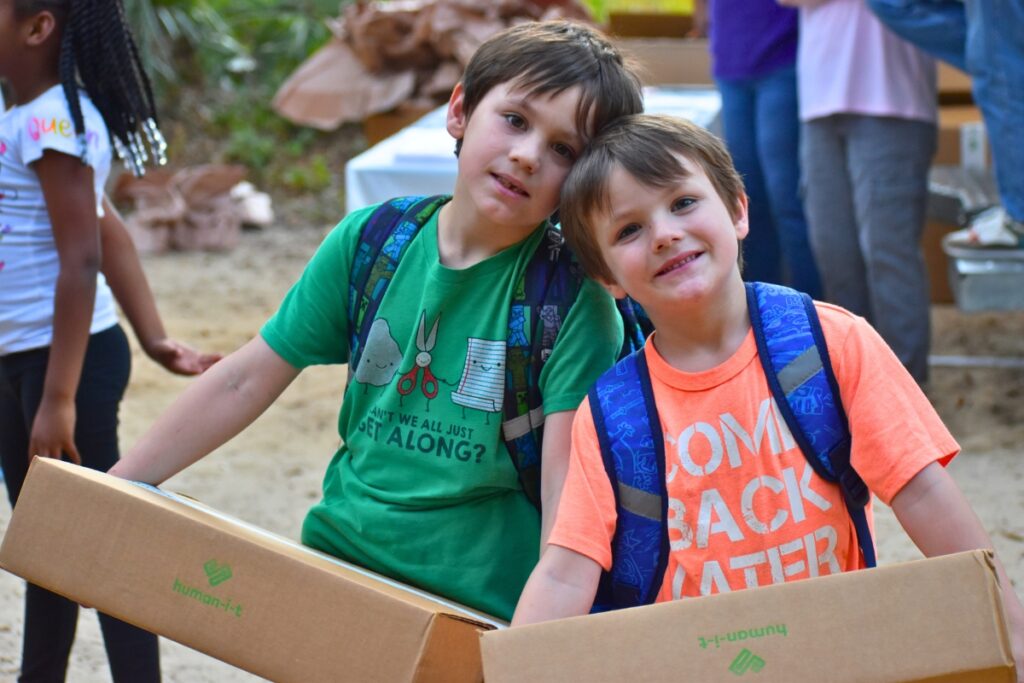 Tuff and Chevy Mitchum pose with their new laptops on Wednesday.