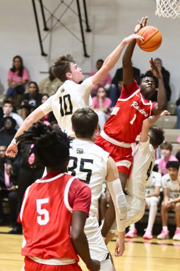 Buchholz's Gabe Thompson blocks Santa Fe's Antonio Hall's shot in the first quarter on Thursday.