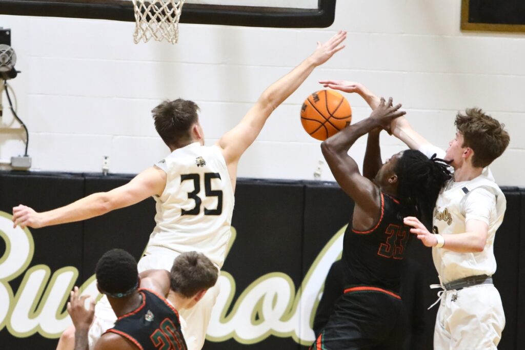 Buchholz's Palmer Walton (35) and Gabe Thompson (10) block Eastside's Davion Pugh.