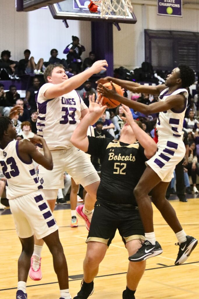 Gainesville's Aiden Bell (33) and Brian Smith (0) block a shot by Buchholz's Dylan Lloyd on Friday.