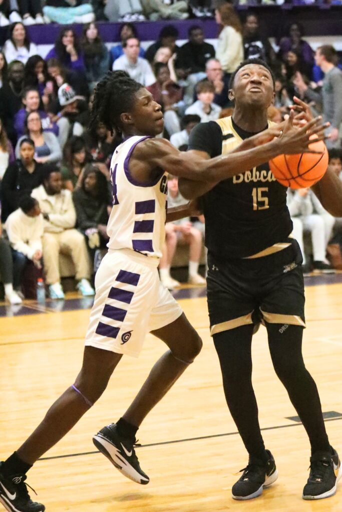 Gainesville's Craig Thomas Jr. swats the ball out of Buchholz's Collin Dunmore's hands on Friday.