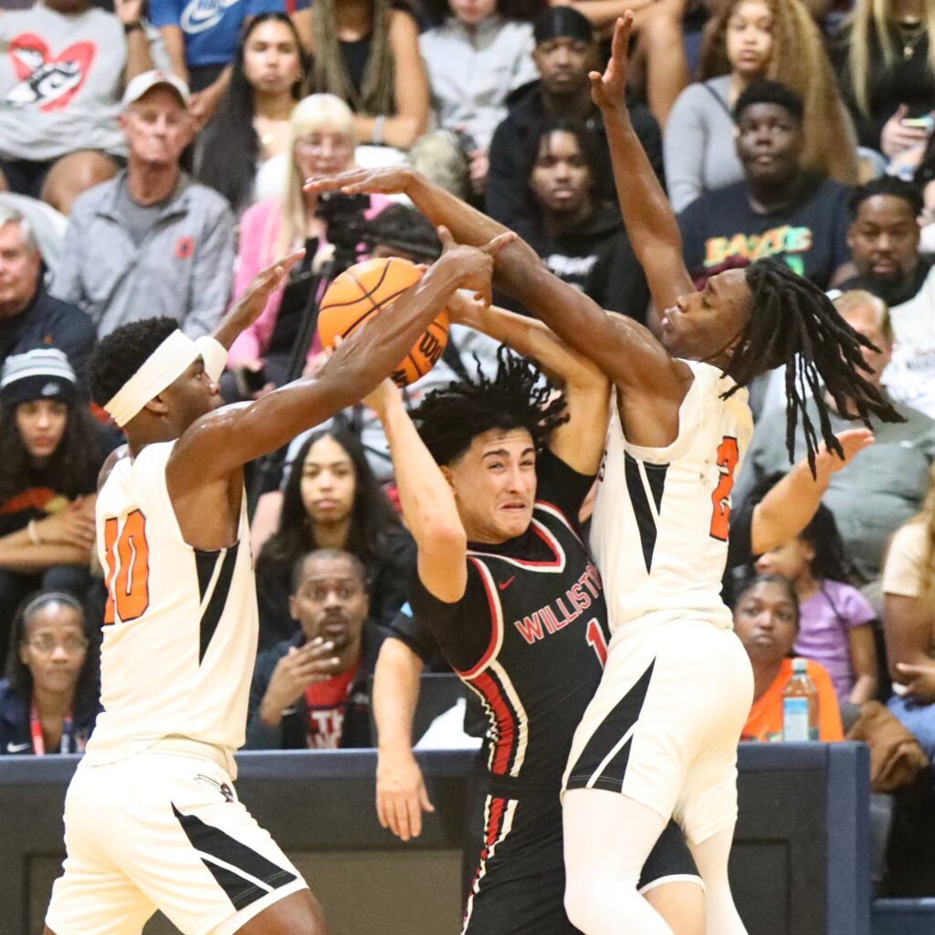 Hawthorne's C.J. Ingram (10) and Alvon Isaac (2) try to steal the ball from Williston's Aramys Rodriguez.