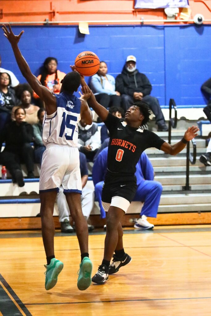 Hawthorne's Darian Bowie and P.K. Yonge's Mareon Bannister battle for a loose ball.