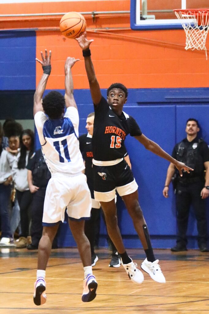 Hawthorne's Frandon Saintfleur attempts a block against P.K. Yonge's Lorenzo Hill.