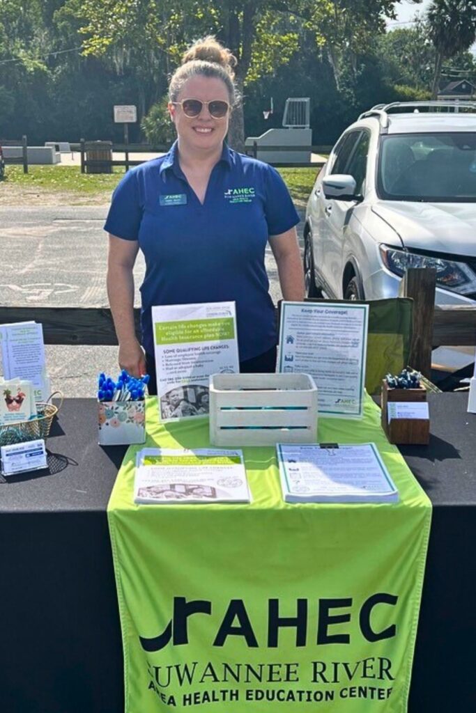 Health insurance navigator Emily Berry sets up a table at an outreach event at one of the counties she serves.