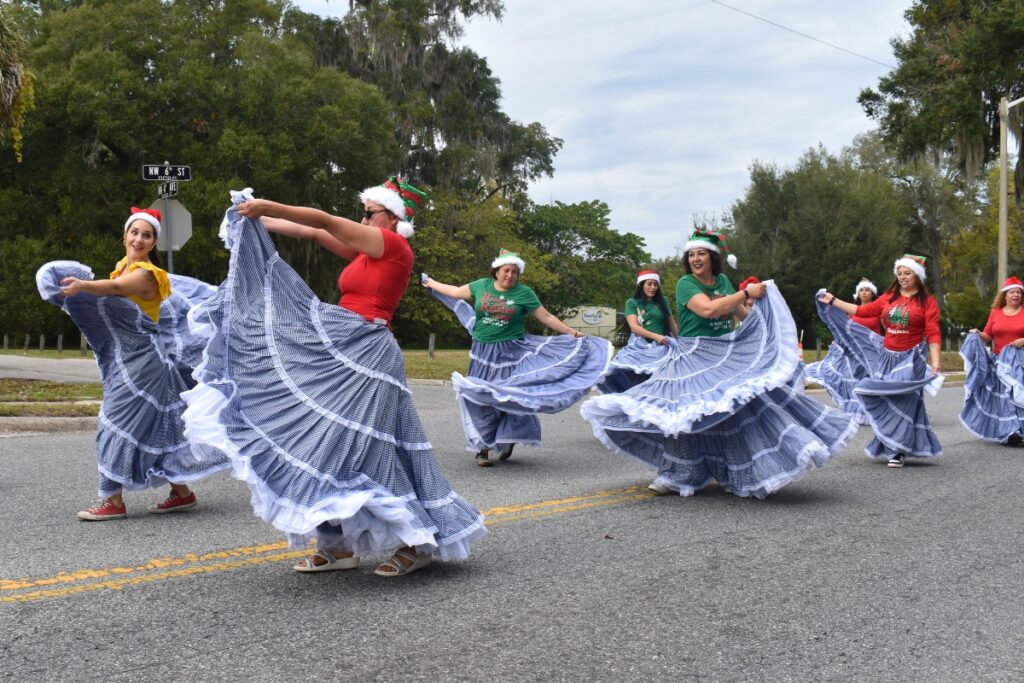 Members of Cumbia Collective wave their skirts in a traditional Columbian dance at A Very GNV Holiday Parade on Saturday.