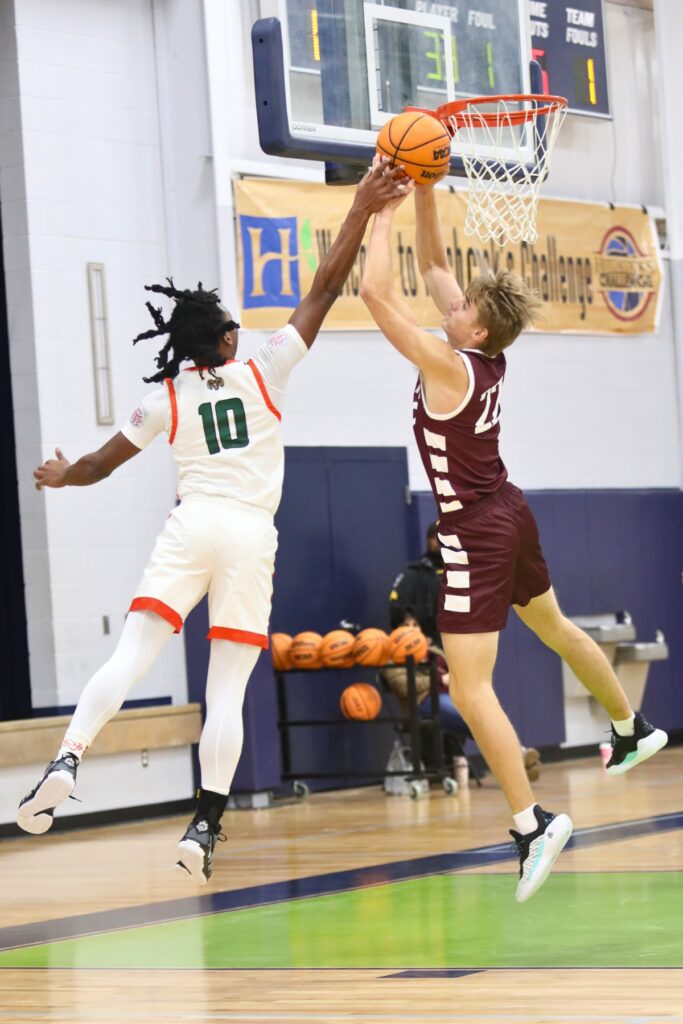 Oak Hall's Andrew Powell grabs a rebound from Eastside's Quashawn Brittingham at the Hitchcock's Challenge.