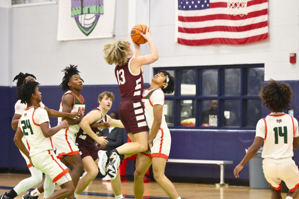 Oak Hall's Cole Snider drives into Eastside's Audric Garcisco at the Hitchcock's Challenge.