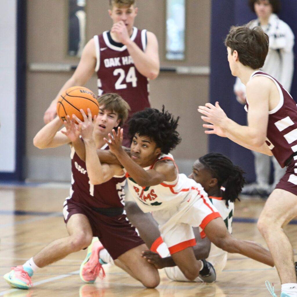 Oak Hall's Jackson Beach and Eastside's Octavious Williams go after a loose ball at the Hitchcock's Challenge.