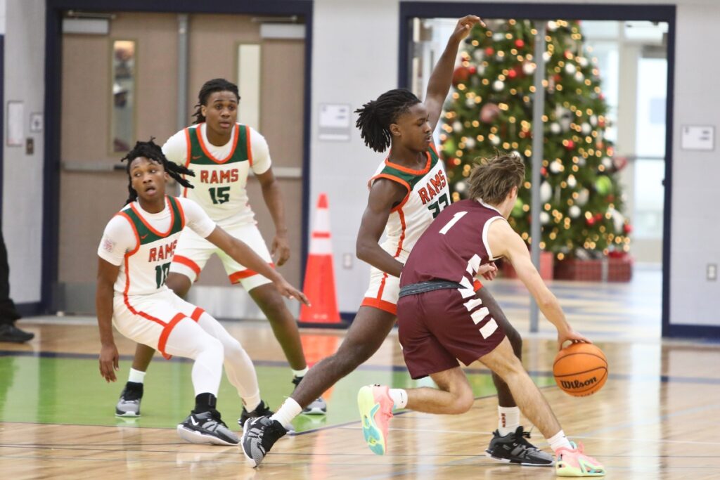 Oak Hall's Jackson Beach drives on Eastside's Davion Pugh at the Hitchcock Challenge.