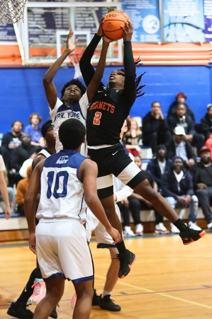 P.K. Yonge's Joel Washington (0) and Hawthorne's Alvon Isaac (2) go for a rebound.
