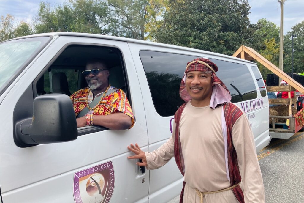 Rod Fair (driving) and Pastor Ron Rawls (dressed as Joseph) of Greater Bethel AME Church at A Very GNV Holiday Parade on Saturday.
