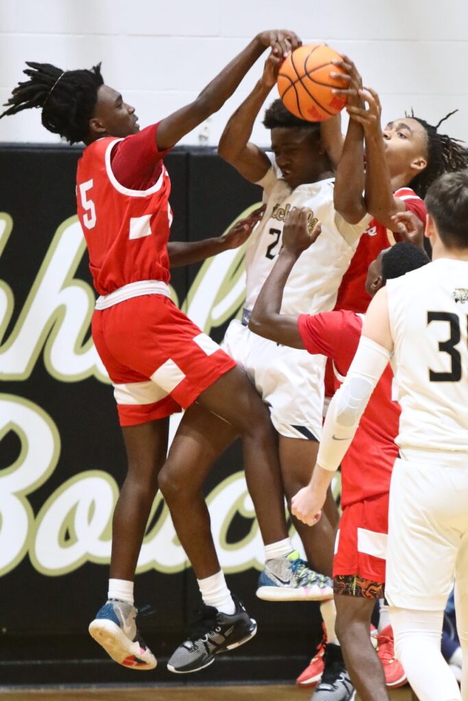 Santa Fe's Mikijah King (5) and Camden McLeod deny Buchholz's Zion Newkirk a shot on Thursday.