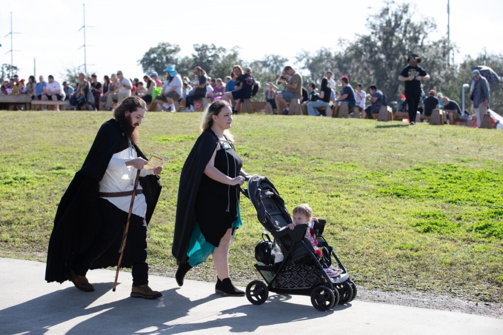 A family navigates the park’s sidewalks.