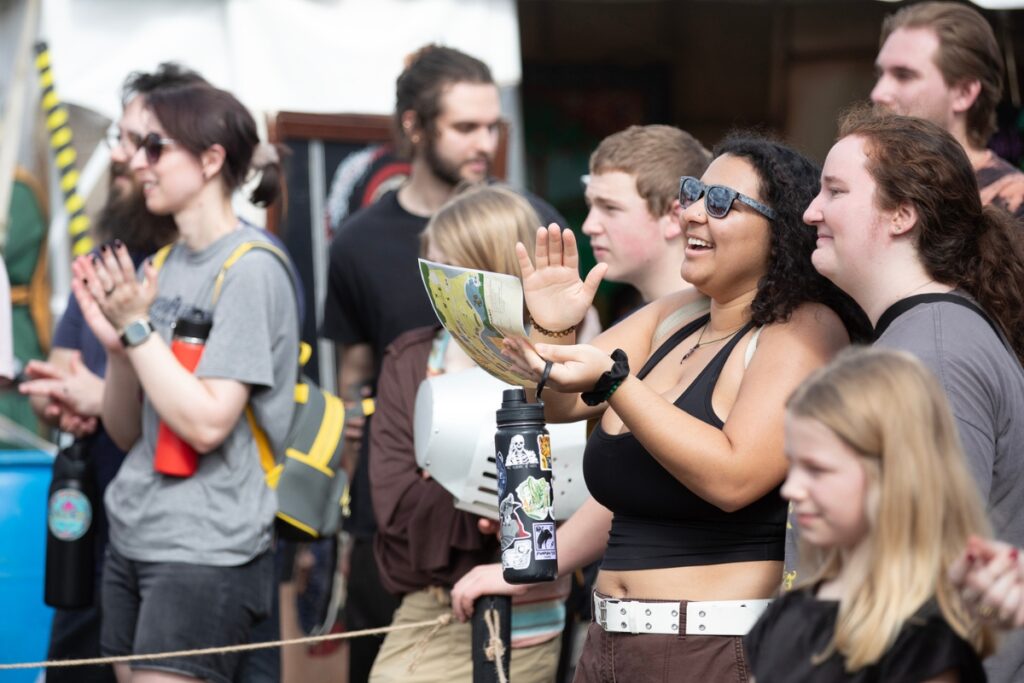 A woman claps with enthusiasm during the Living Chessboard tournament.