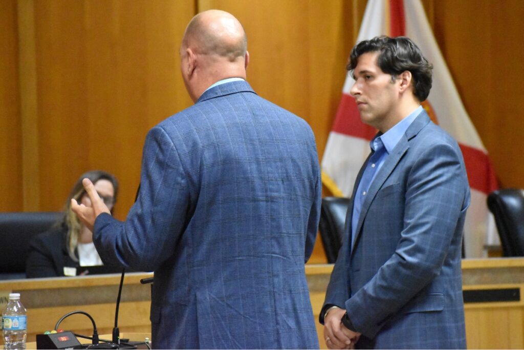Alachua Chamber of Commerce's Mitch Glaeser (left) and Adam Boukari (right) speak to the Alachua City Commission.