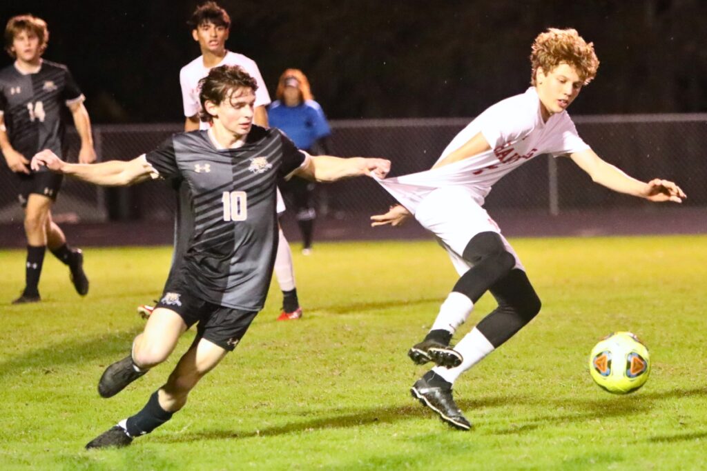 Buchholz's Benjamin Zeig snags Kishore Rose Dewil's jersey against Santa Fe.