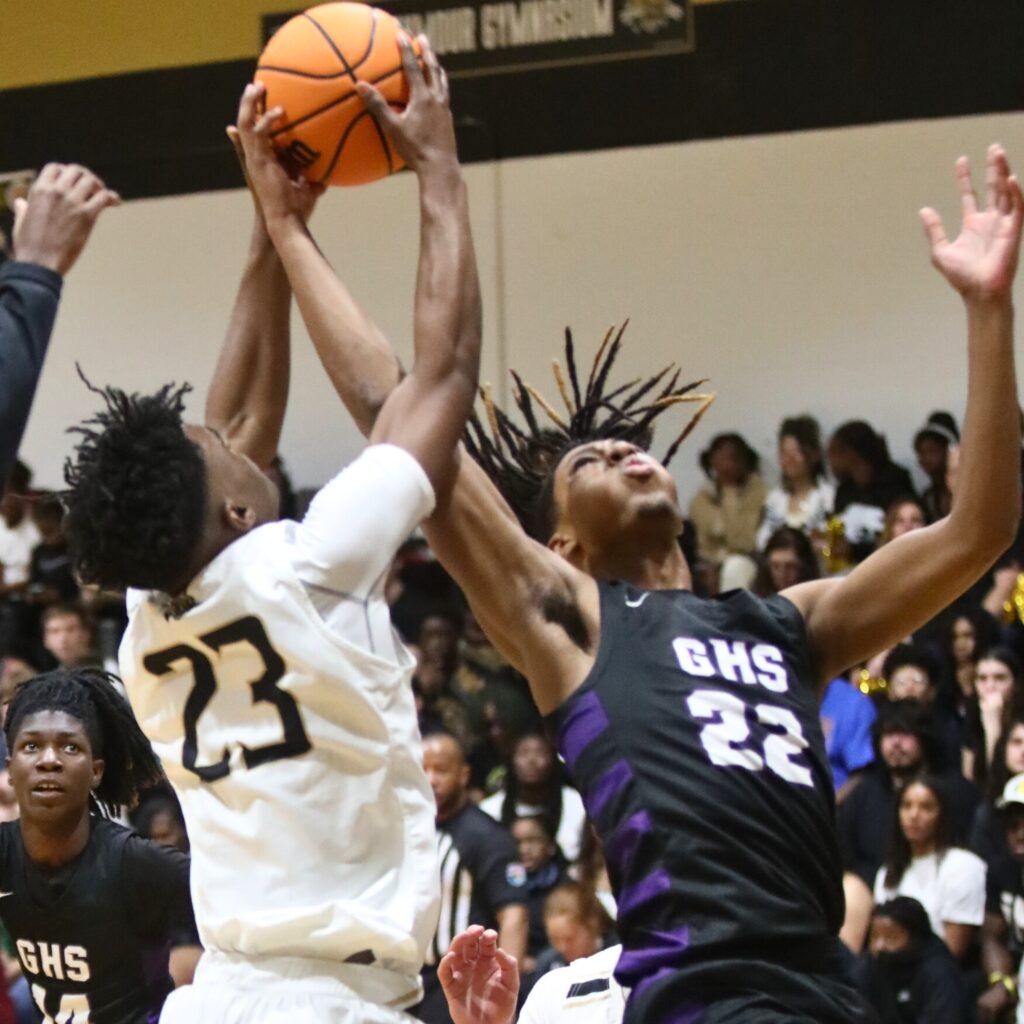 Buchholz's Kewan Hall and Gainesville's Cornelius White battle for a rebound.