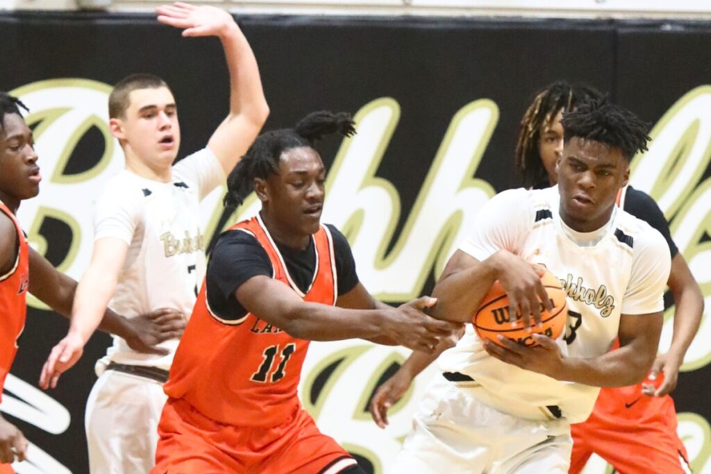 Buchholz's Kewan Hall grabs a loose ball against Lakeland.