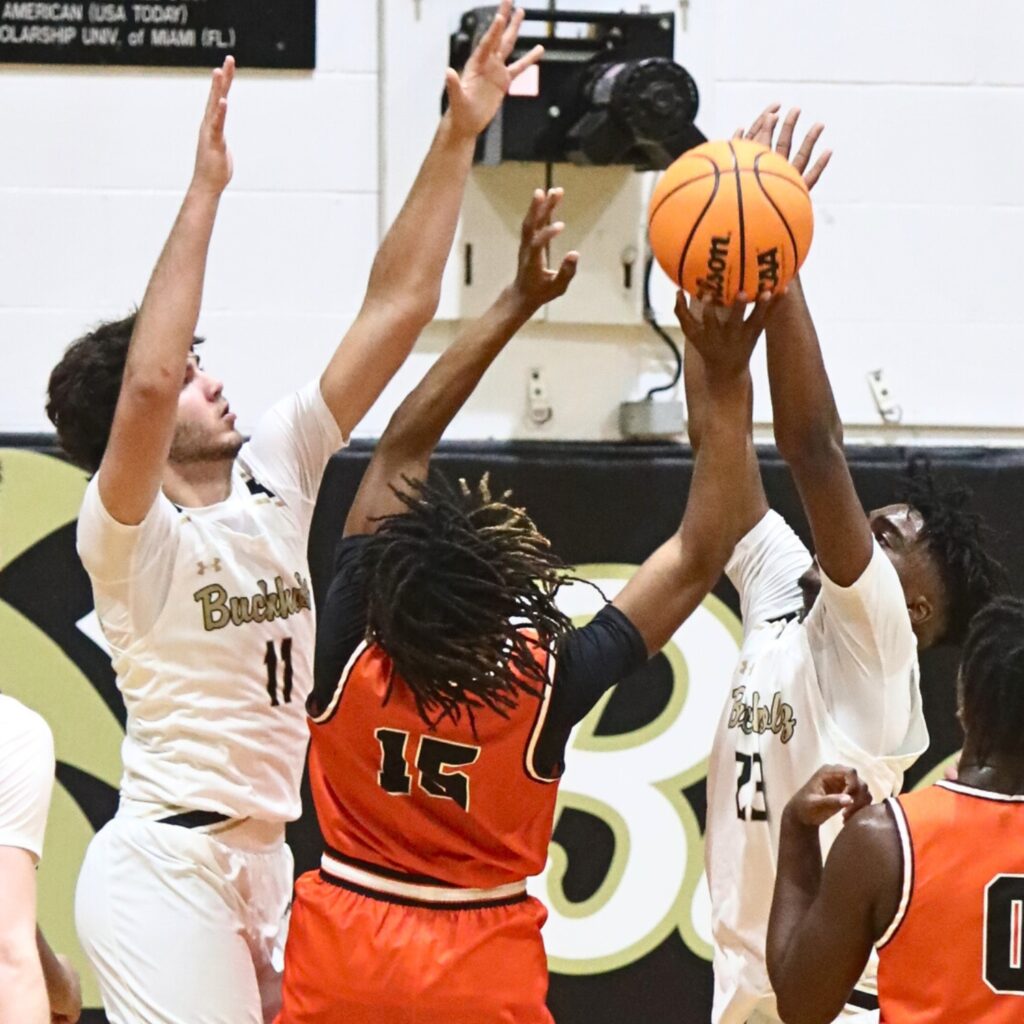 Buchholz's Nate Muchnick (11) and Kewan hall (23) defend a Lakeland shot attempt.